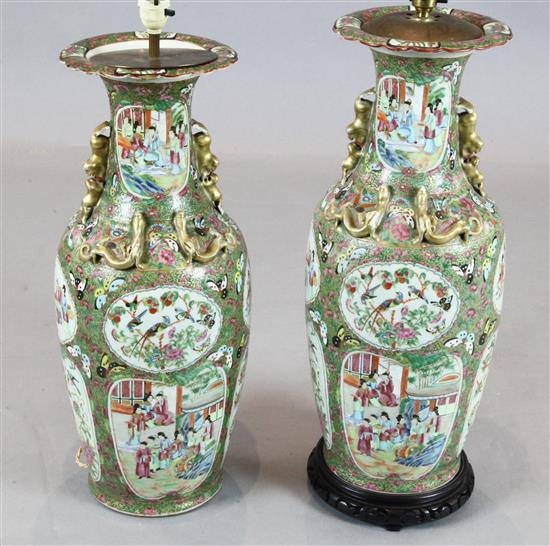 A pair of large Chinese Canton-decorated famille rose vases, 61.5cm excl. later lamp fittings and stands, converted, restorations